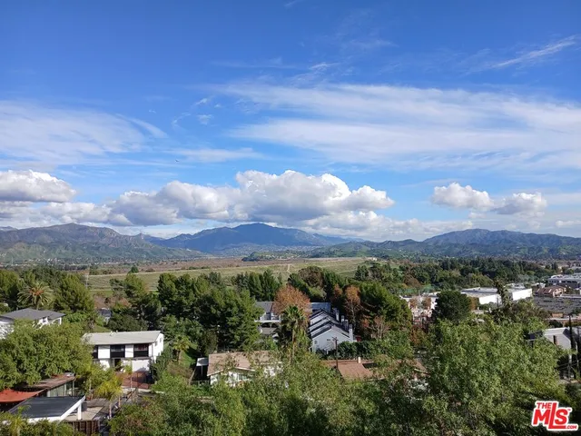 a view of a city with lush green forest