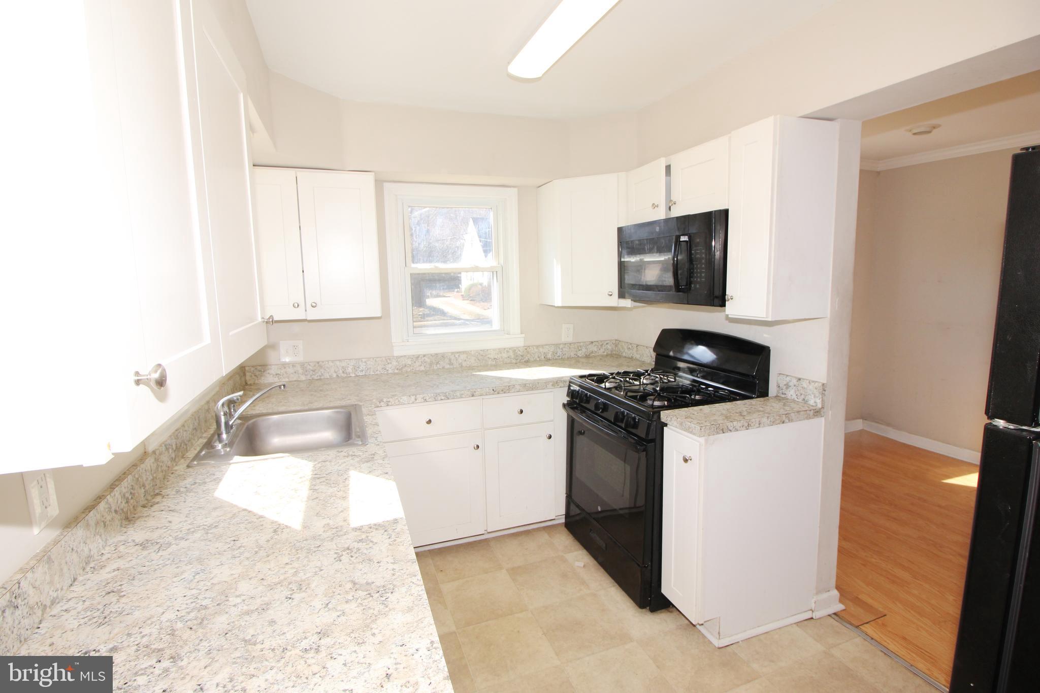 63 Ridgley Street Mount Holly, NJ 08060 - Photo 12 of 30 a kitchen with a stove and a sink
