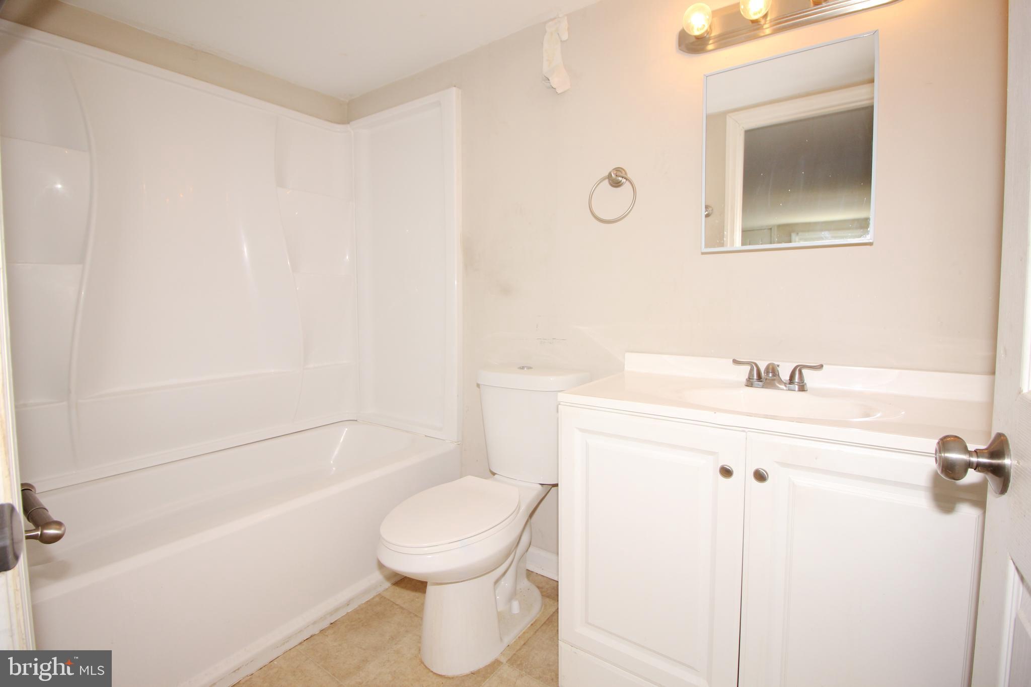 63 Ridgley Street Mount Holly, NJ 08060 - Photo 18 of 30 a bathroom with a sink a toilet and shower