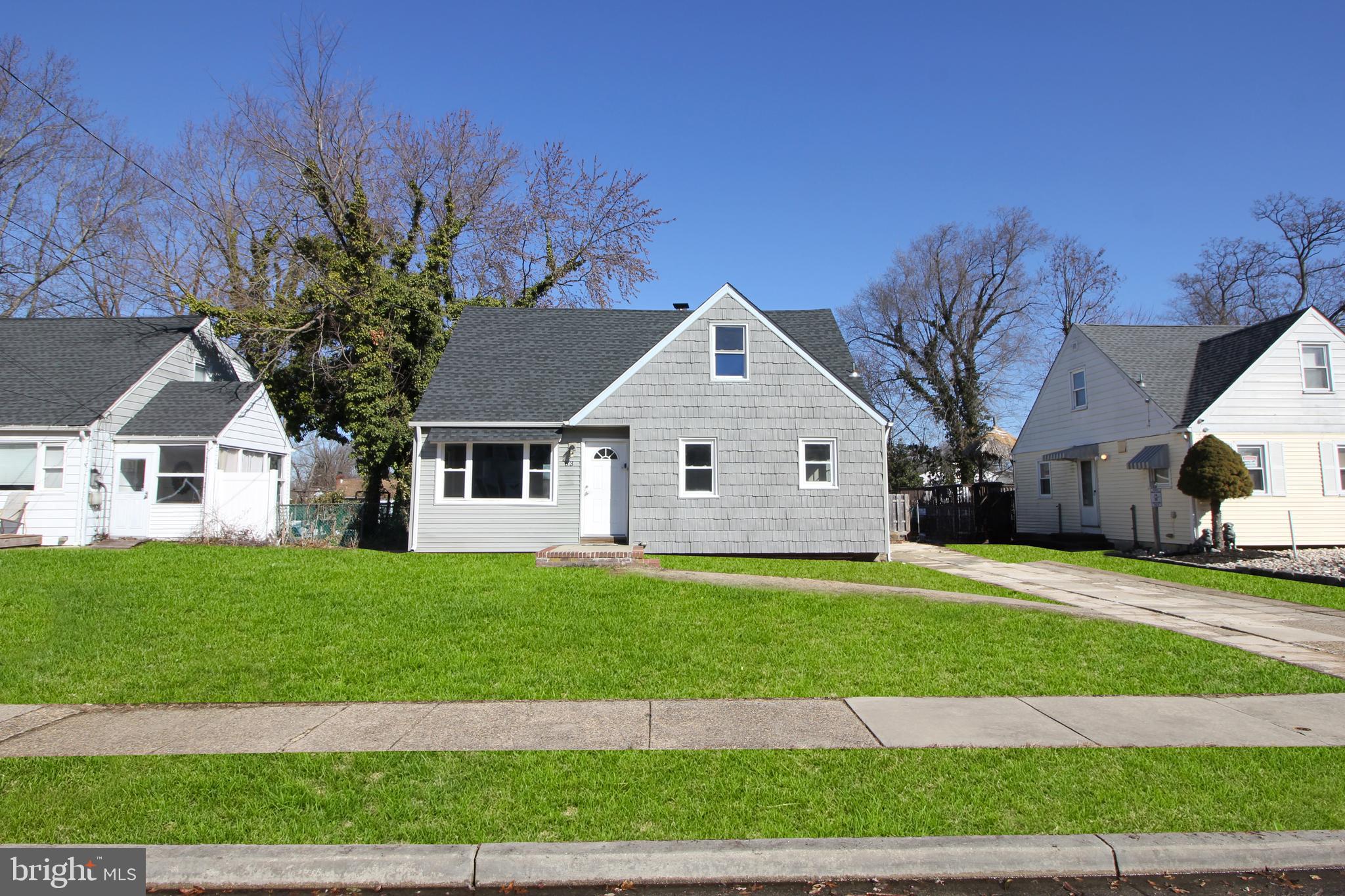 63 Ridgley Street Mount Holly, NJ 08060 - Photo 2 of 30 a front view of a house with a yard and garage