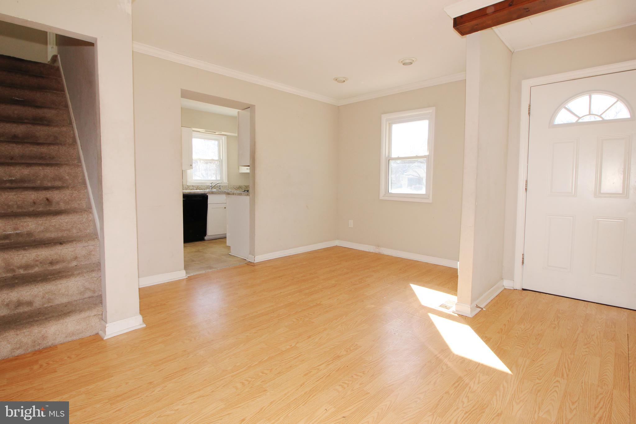 63 Ridgley Street Mount Holly, NJ 08060 - Photo 9 of 30 a view of an empty room with wooden floor and a window