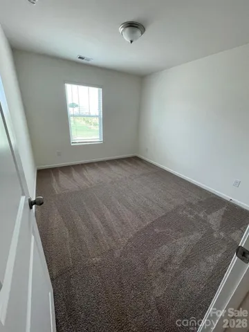 an entryway of a house with wooden floor and a hallway