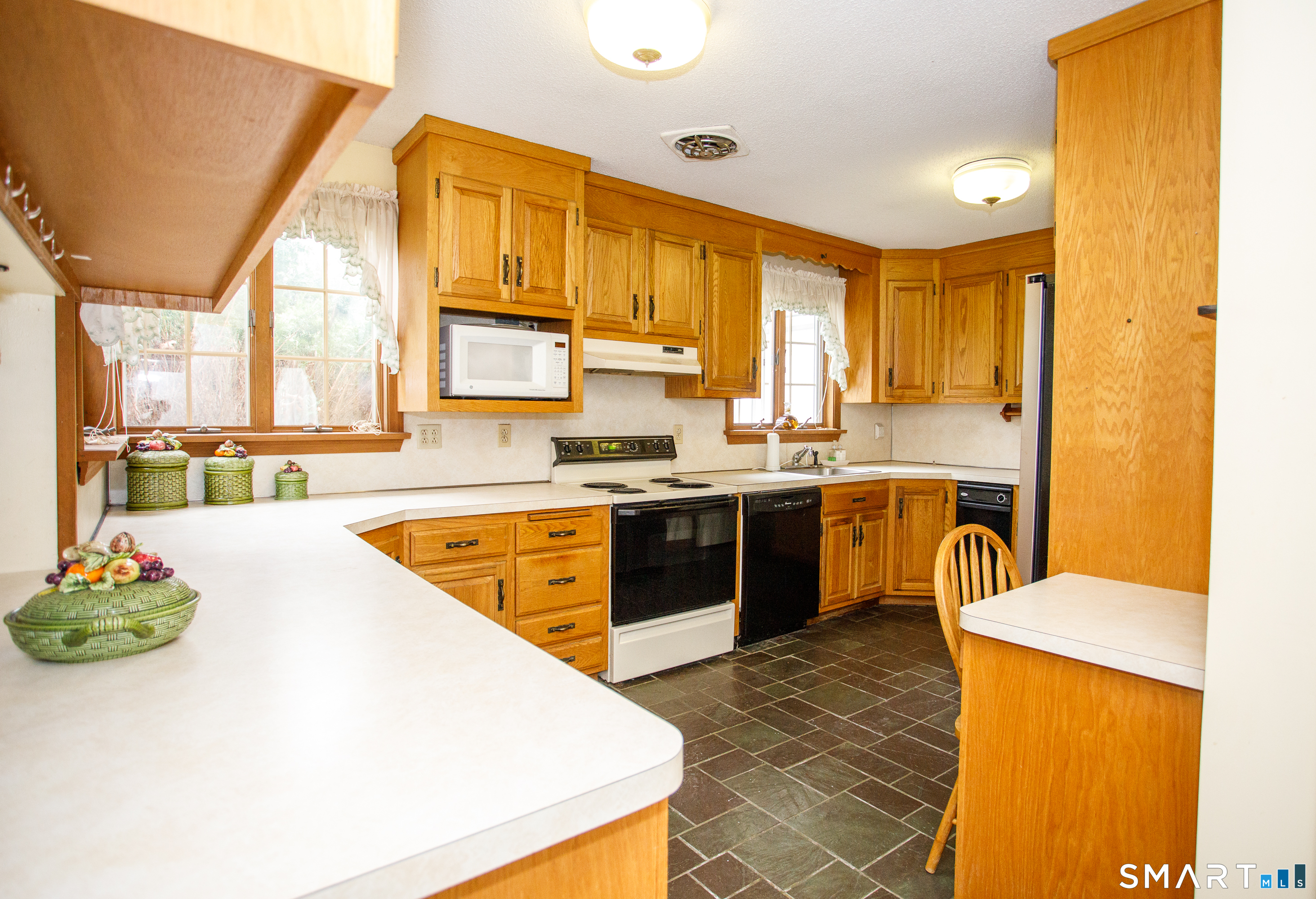 164 Harland Road Norwich, CT 06360 - Photo 11 of 29 a kitchen with stainless steel appliances granite countertop a sink a stove and a refrigerator