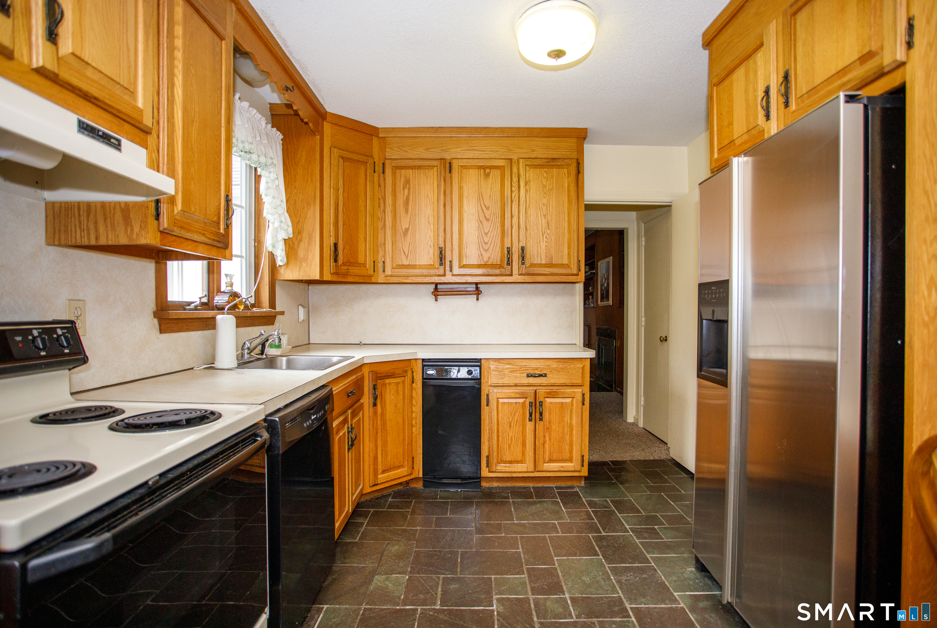 164 Harland Road Norwich, CT 06360 - Photo 14 of 29 a kitchen with stainless steel appliances a stove a sink and a refrigerator