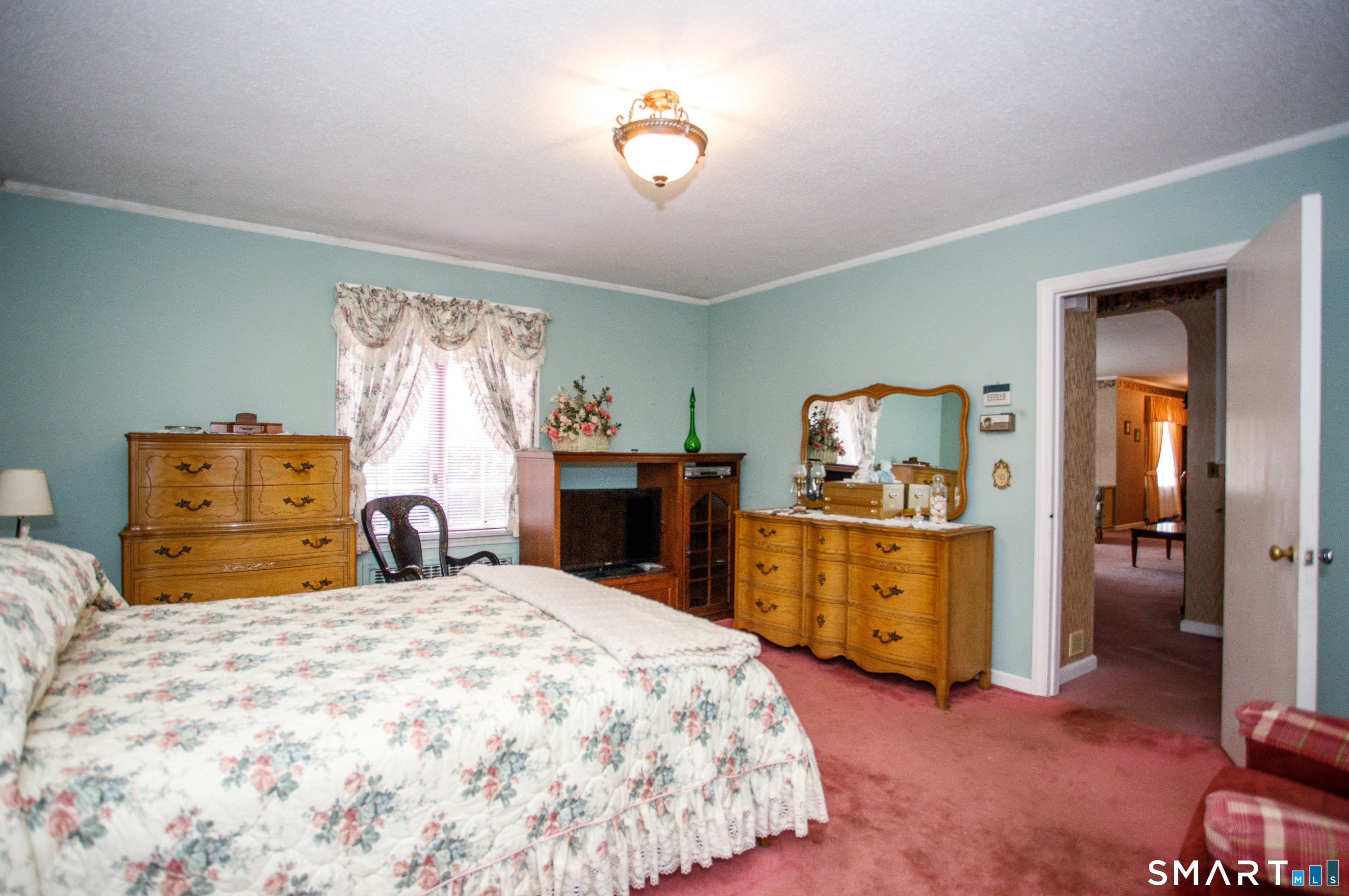 164 Harland Road Norwich, CT 06360 - Photo 21 of 29 a bedroom with a bed and a chandelier