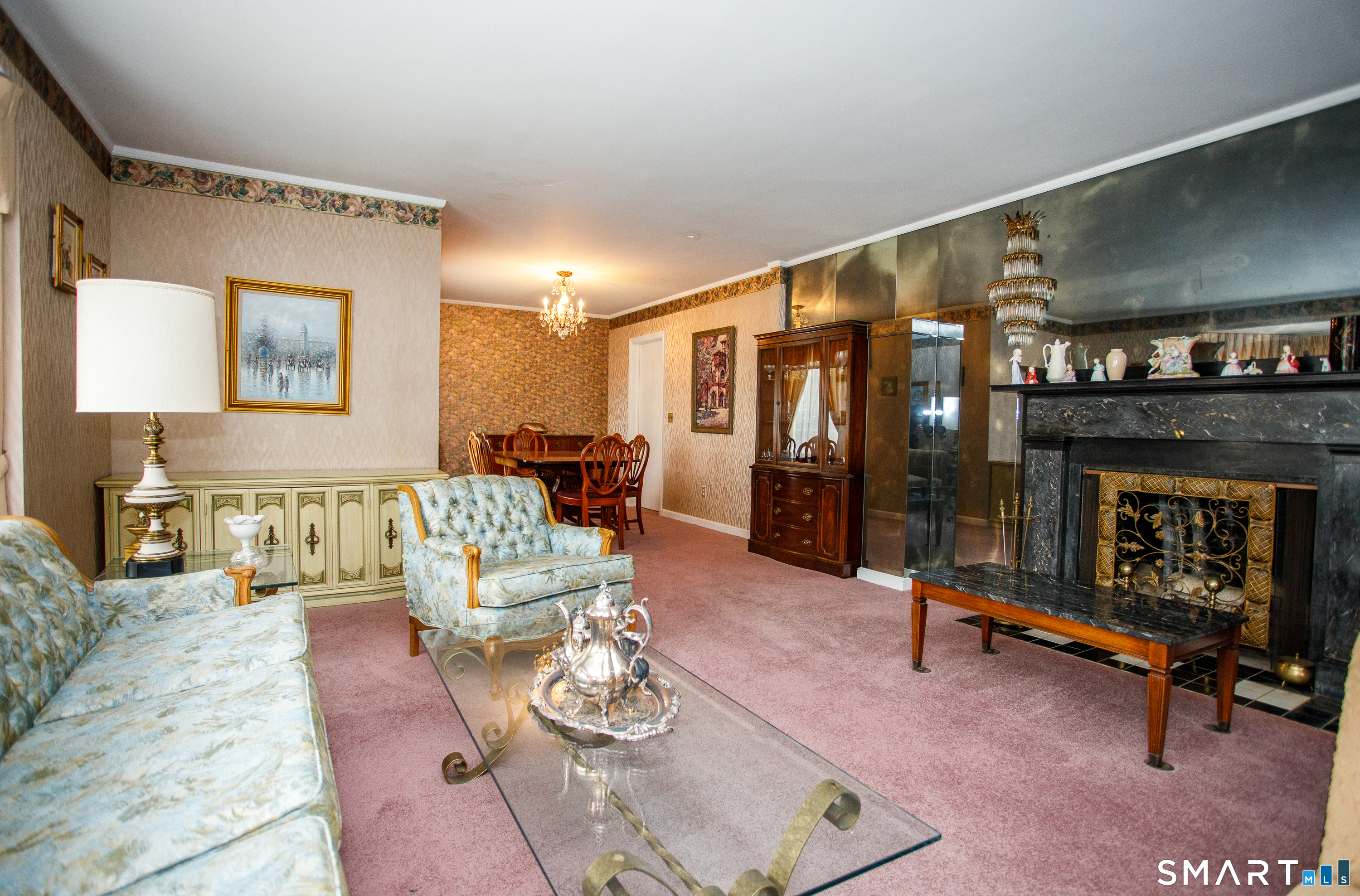 164 Harland Road Norwich, CT 06360 - Photo 7 of 29 a living room with furniture a fireplace and gym equipment