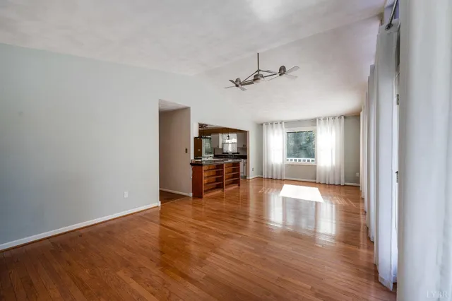 a view of a livingroom with wooden floor and a flat screen tv