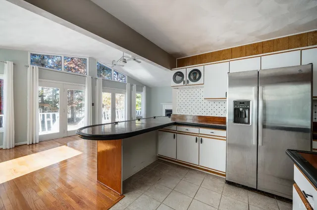 an empty room with a window and a fan