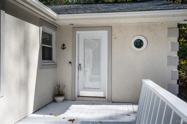 a view of a house with big yard plants and large trees