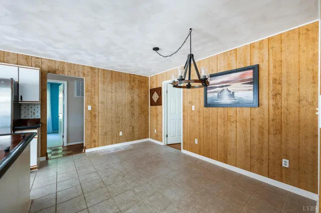 a kitchen with kitchen island granite countertop a refrigerator a sink and dishwasher