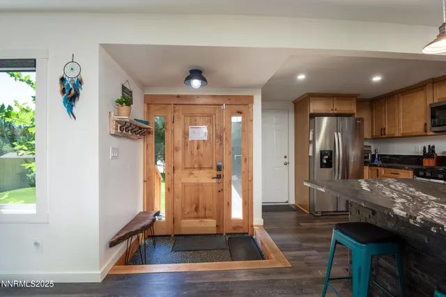 a kitchen with stainless steel appliances granite countertop a refrigerator and a stove top oven