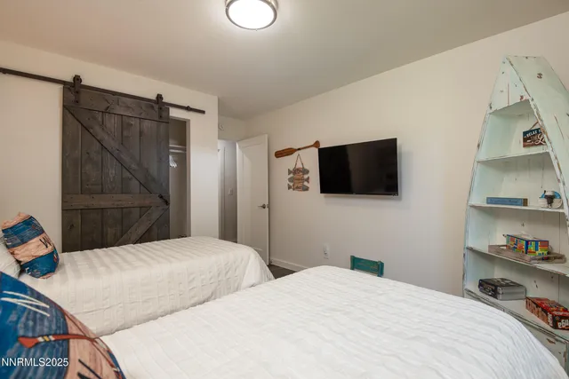 a bedroom with a bed and a flat screen tv