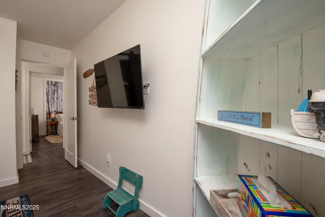 a view of hallway with wooden floor