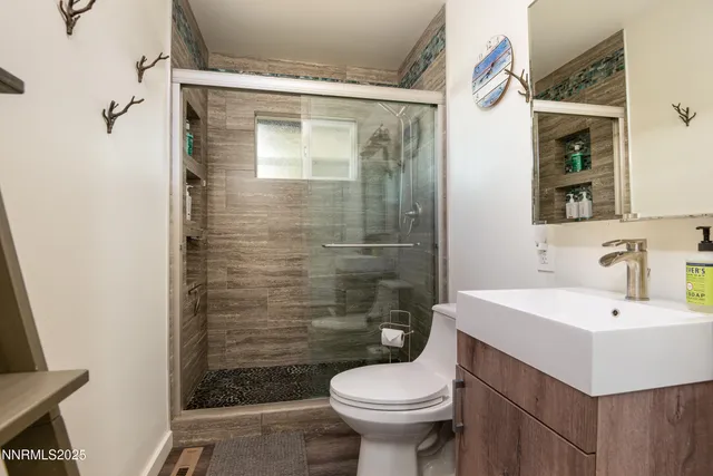 a bathroom with a sink toilet and shower