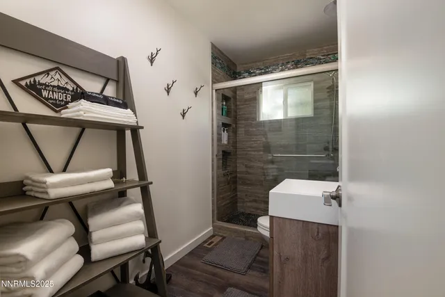 a bathroom with a toilet and a shower