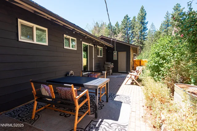 a view of a patio with table and chairs and potted plants