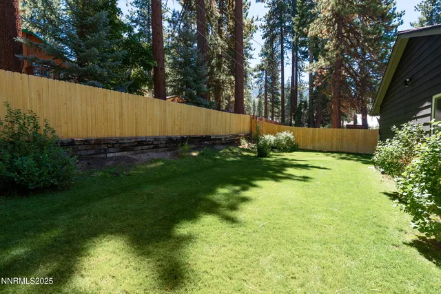 a front view of house with yard and trees