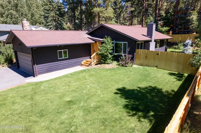 an aerial view of house with yard swimming pool and outdoor seating