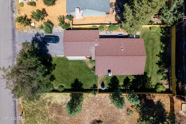 an aerial view of a house with a yard basket ball court and outdoor seating