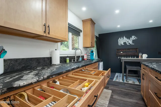 a kitchen with stainless steel appliances granite countertop a stove a sink and a microwave
