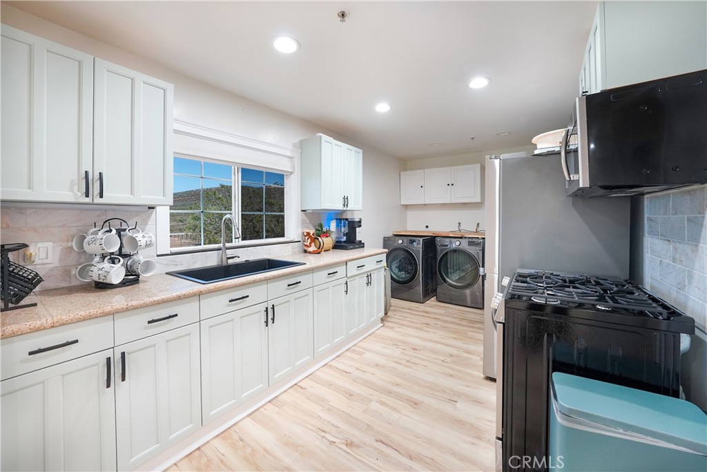 2165 Lilac Road Ramona, CA 92065 - Photo 13 of 49 a kitchen with granite countertop a sink appliances and cabinets