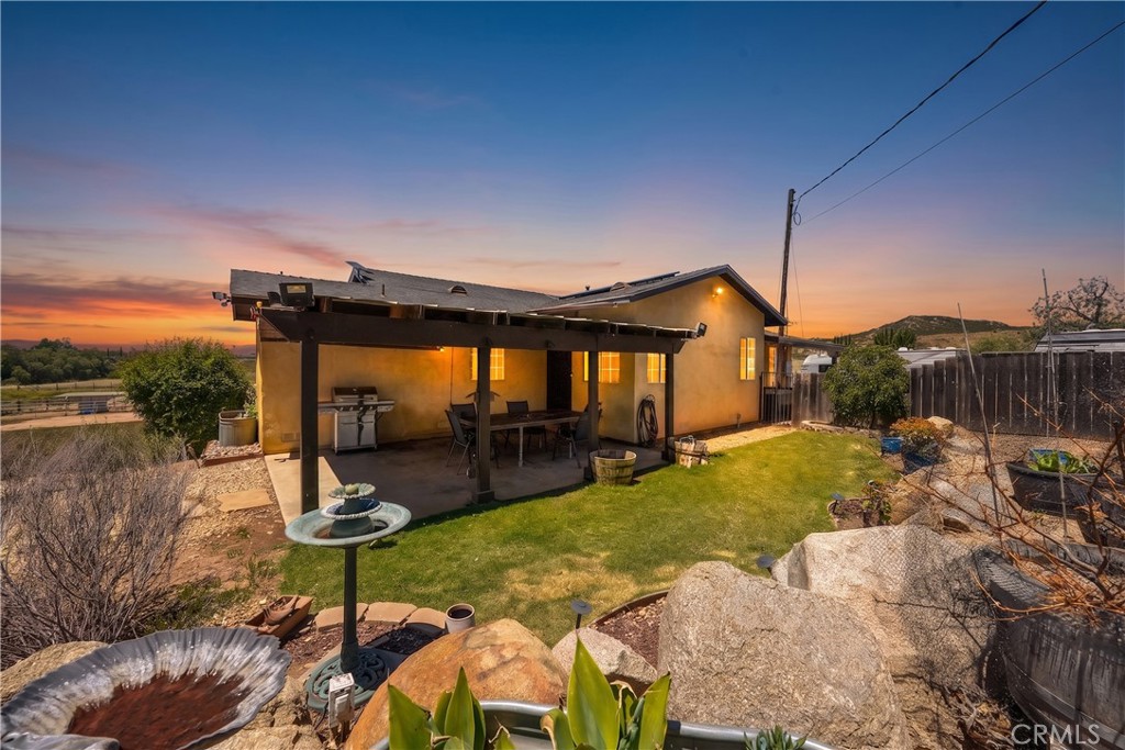 2165 Lilac Road Ramona, CA 92065 - Photo 5 of 49 a backyard of a house with table and chairs