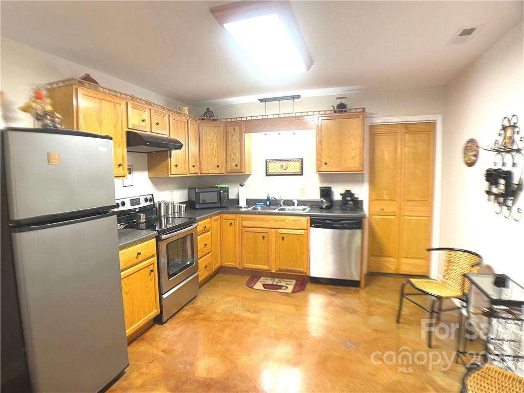 369 Pinecrest Circle Troy, NC 27371 - Photo 3 of 6 a kitchen with stainless steel appliances a refrigerator sink and white cabinets