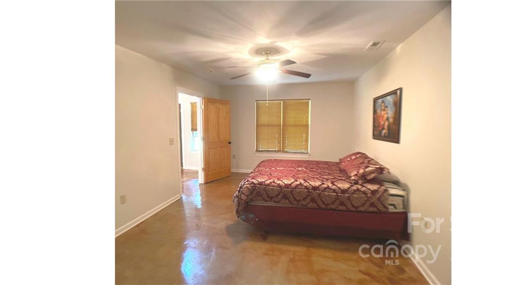 369 Pinecrest Circle Troy, NC 27371 - Photo 5 of 6 a bedroom with a bed and a chandelier