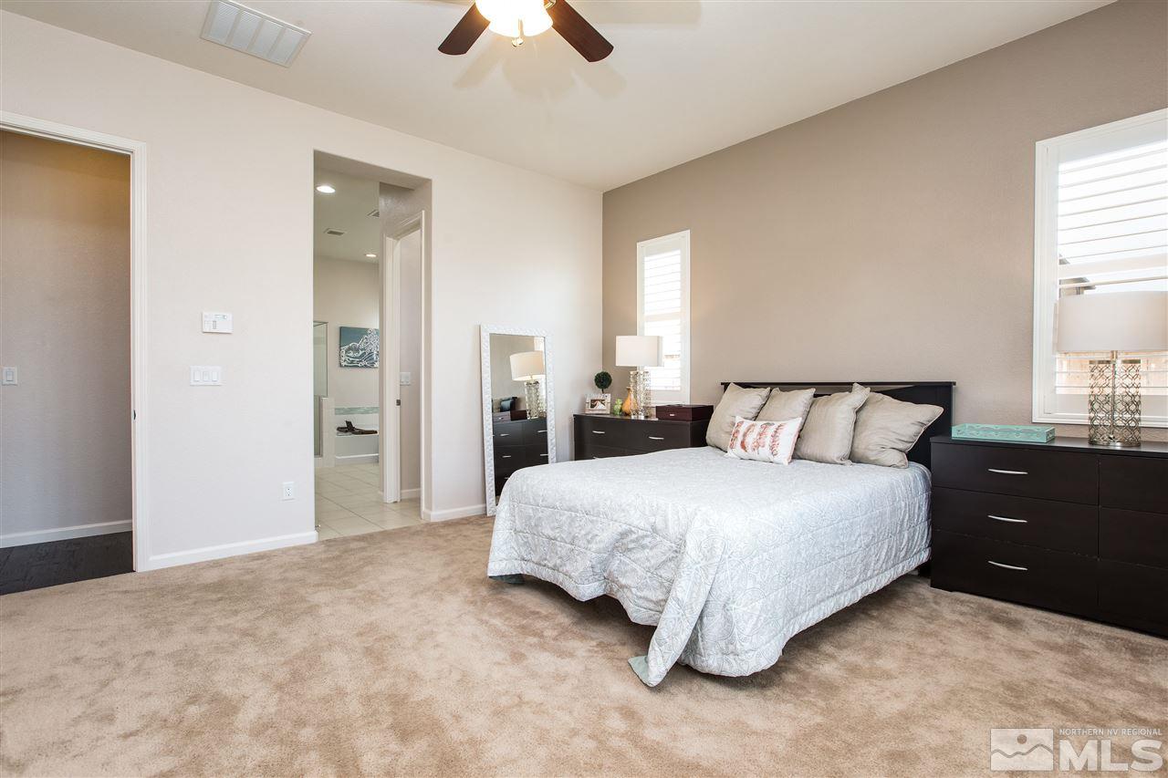 3045 Show Jumper Lane Reno, NV 89521 - Photo 11 of 22 a spacious bedroom with a bed and a lamp