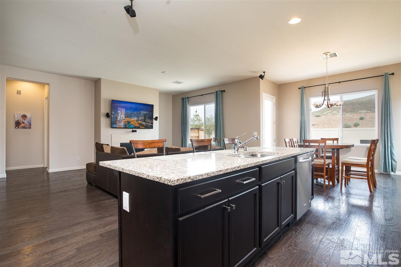 3045 Show Jumper Lane Reno, NV 89521 - Photo 4 of 22 a kitchen with center island and stainless steel appliances