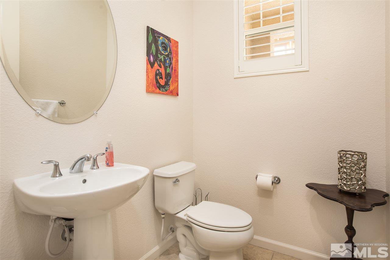 3045 Show Jumper Lane Reno, NV 89521 - Photo 6 of 22 a bathroom with a toilet sink and mirror