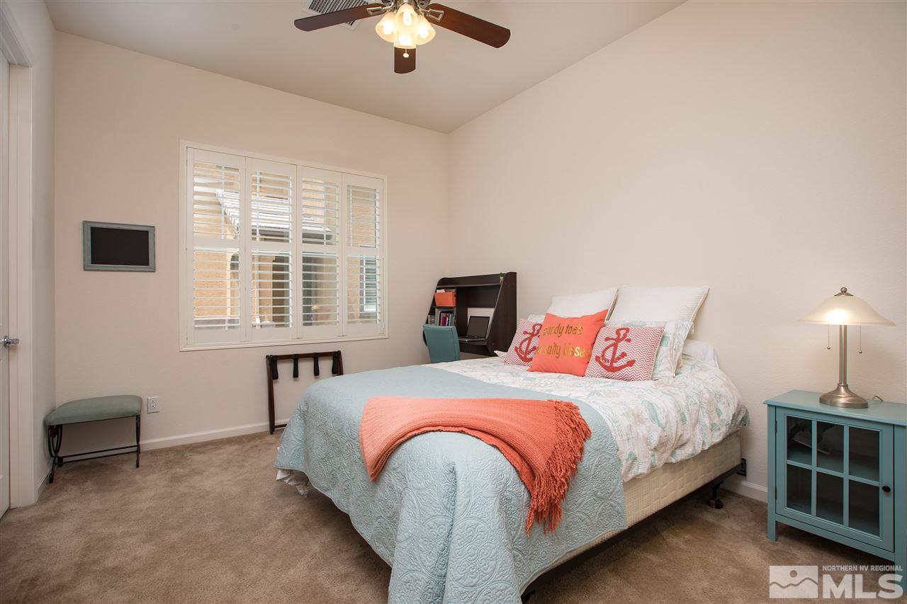 3045 Show Jumper Lane Reno, NV 89521 - Photo 7 of 22 a bedroom with a bed and a chandelier