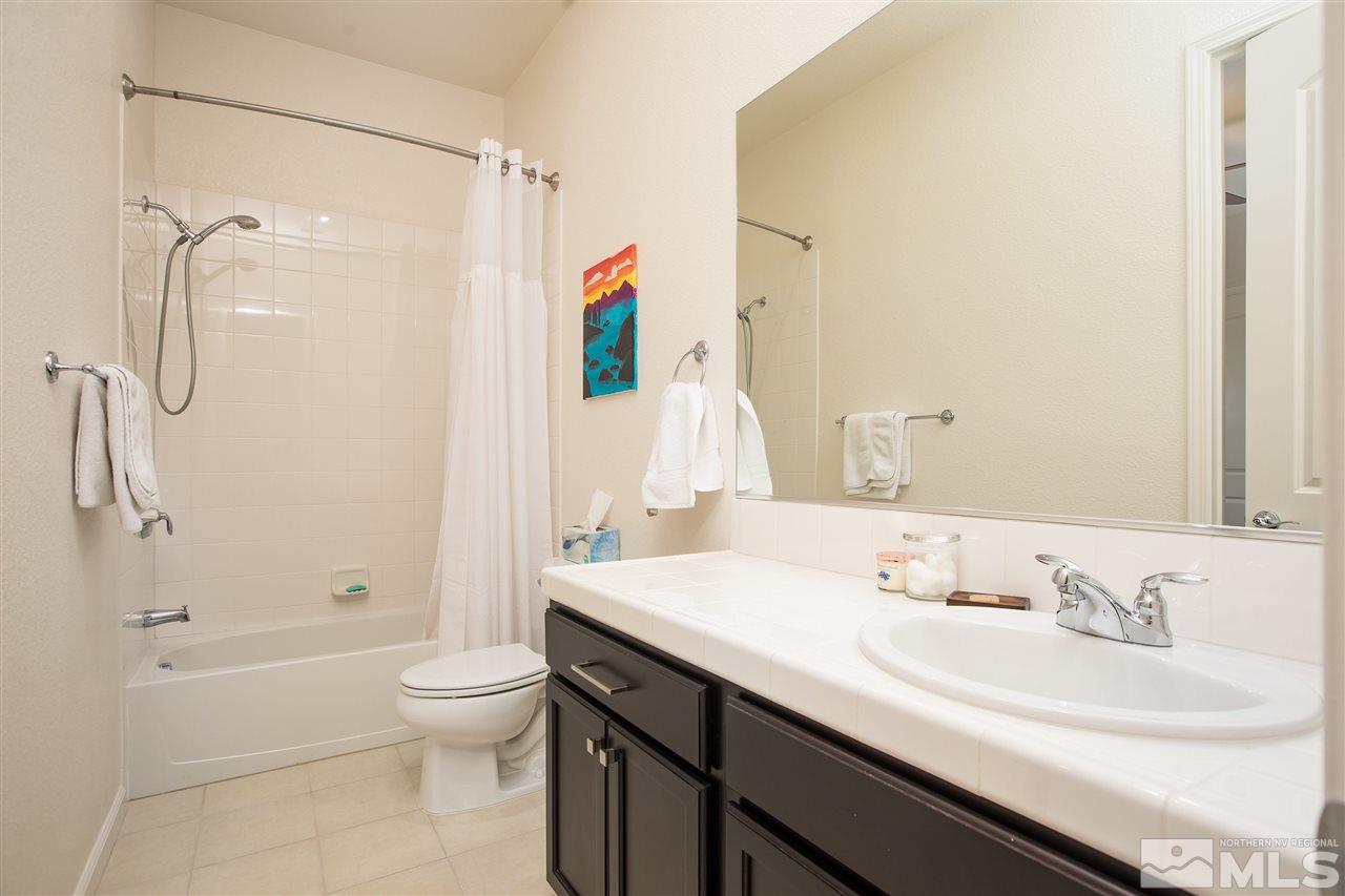 3045 Show Jumper Lane Reno, NV 89521 - Photo 8 of 22 a bathroom with a sink a toilet and shower