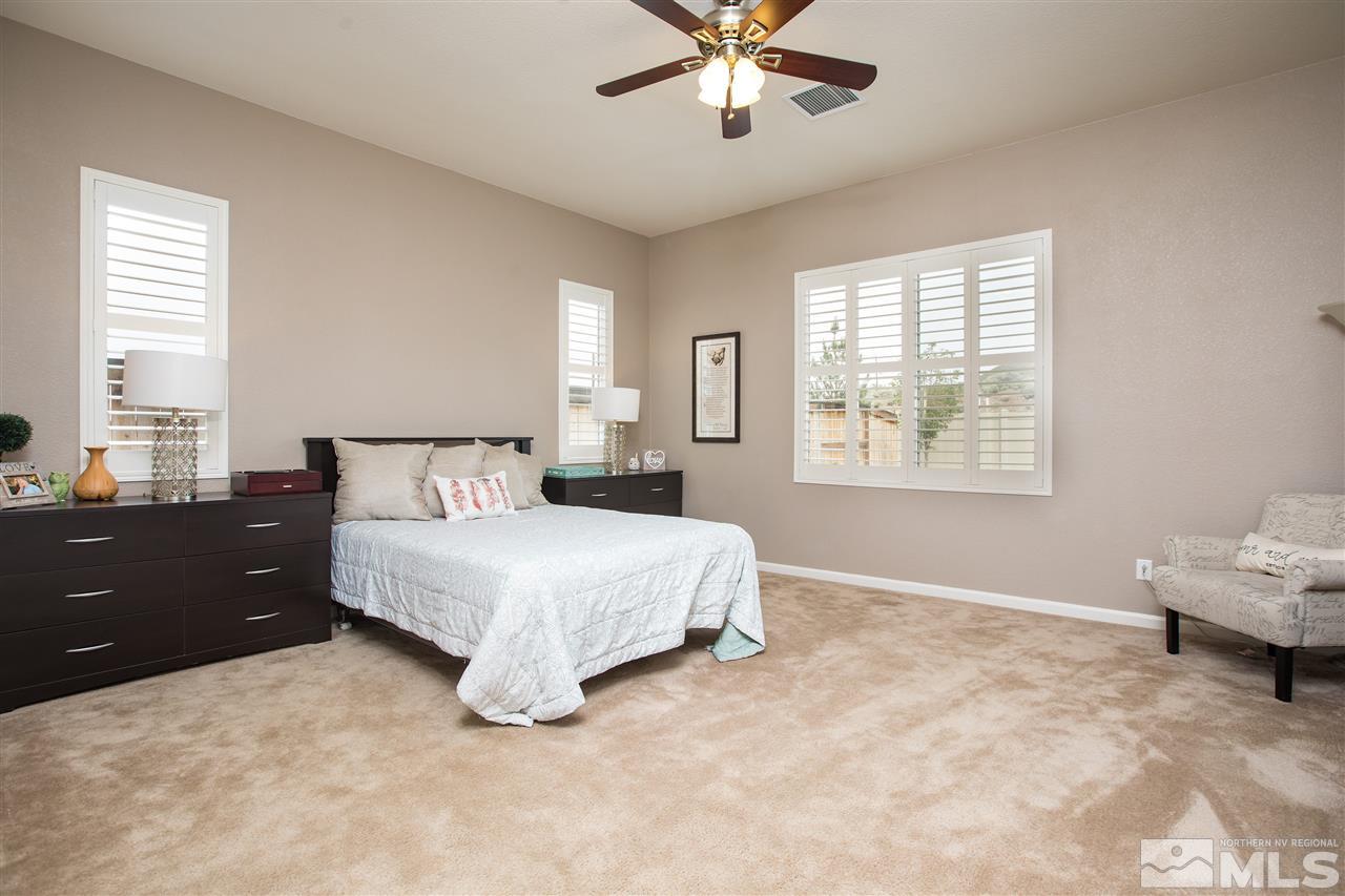 3045 Show Jumper Lane Reno, NV 89521 - Photo 9 of 22 a spacious bedroom with a large bed and a window