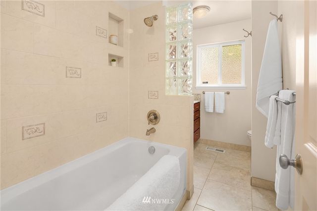 a bathroom with a bathtub and shower