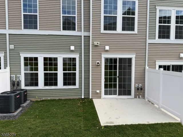a view of a house with a large window and a yard