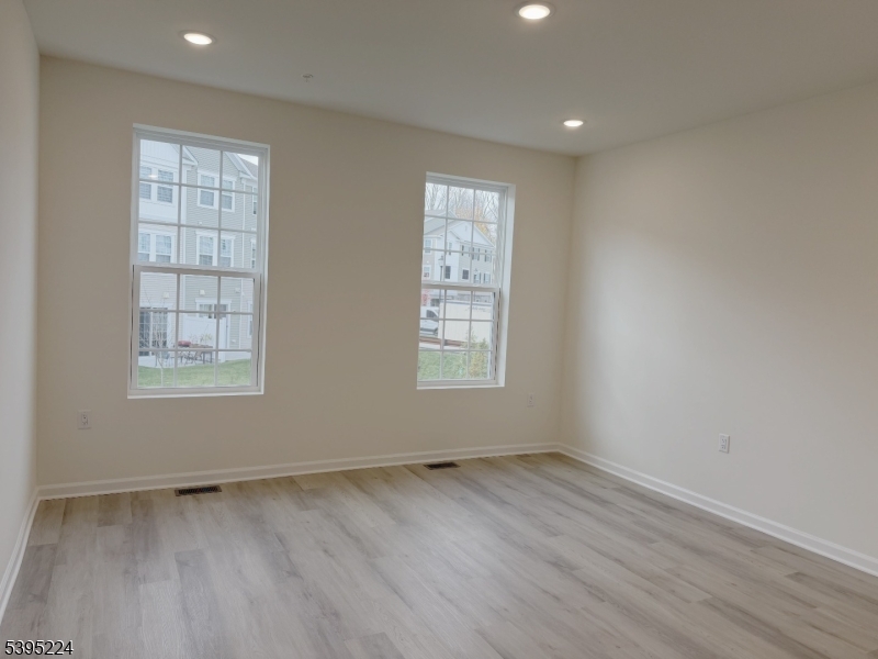 107 Myrtle Road Warren, NJ 07059 - Photo 6 of 12 an empty room with wooden floor and windows