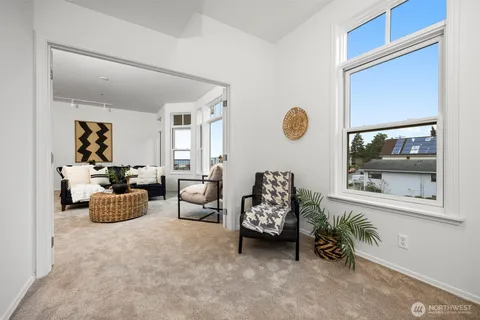 a view of living room with furniture and large window