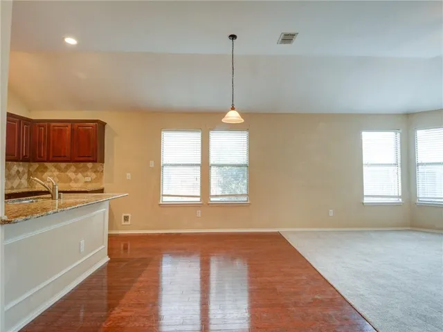 a view of a kitchen with a stove cabinets and a wooden floor