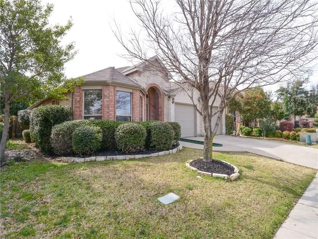 a front view of a house with a yard garage and outdoor seating