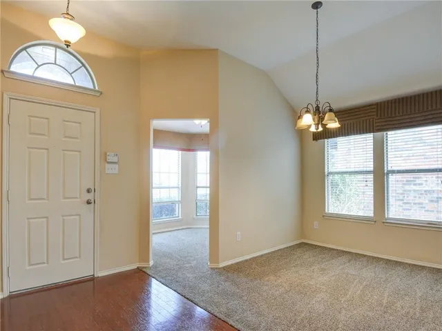 a view of livingroom with window wooden floor and chandelier
