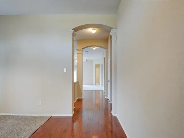 a view of a hallway with wooden floor