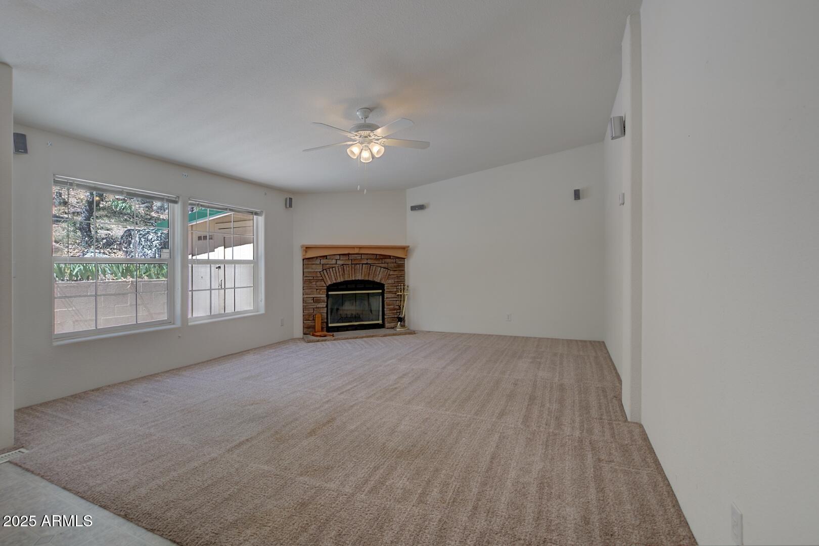405 East Cherry Street Payson, AZ 85541 - Photo 13 of 47 a view of empty room with a fireplace and a window