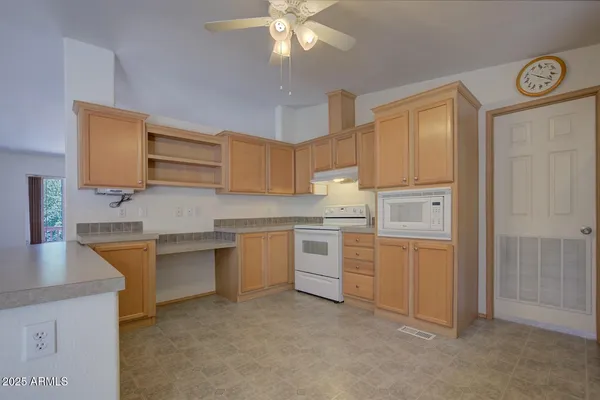 a white refrigerator freezer sitting inside of a kitchen