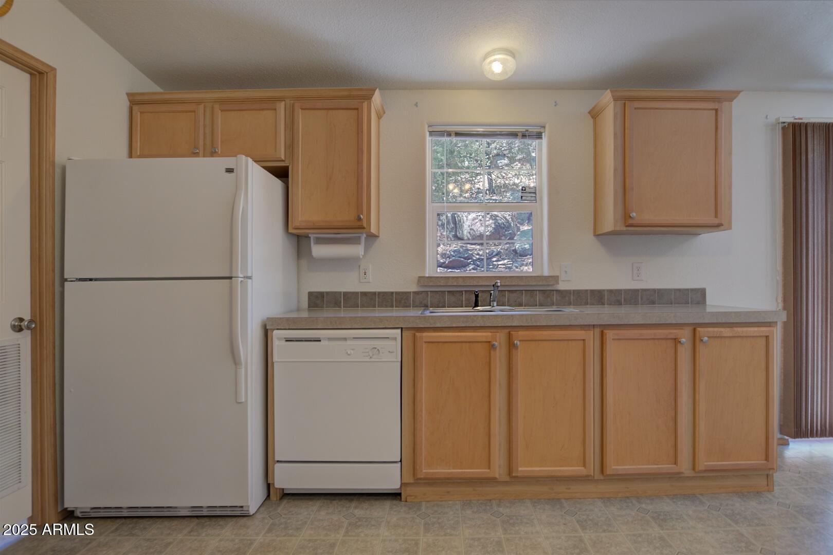 405 East Cherry Street Payson, AZ 85541 - Photo 16 of 47 a white refrigerator freezer sitting inside of a kitchen