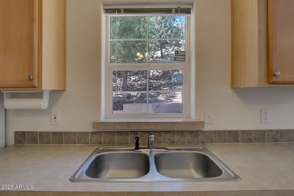 a view of a dining room with furniture and a chandelier