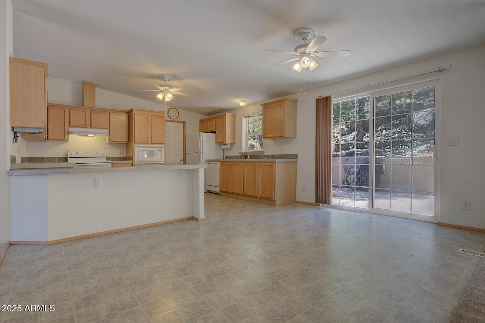 405 East Cherry Street Payson, AZ 85541 - Photo 19 of 47 a kitchen with stainless steel appliances granite countertop a stove top oven a sink with granite countertops and cabinets