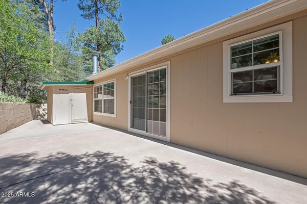 a view of empty room with a fireplace and fan
