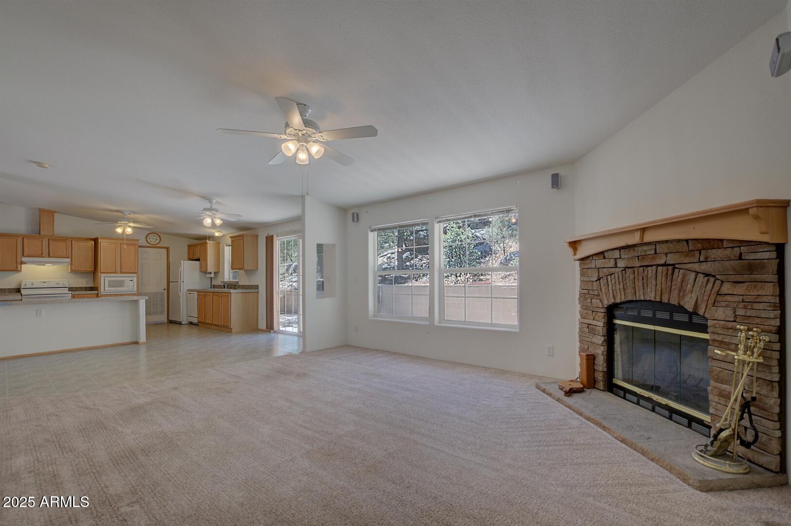 405 East Cherry Street Payson, AZ 85541 - Photo 21 of 47 a view of empty room with a fireplace and fan