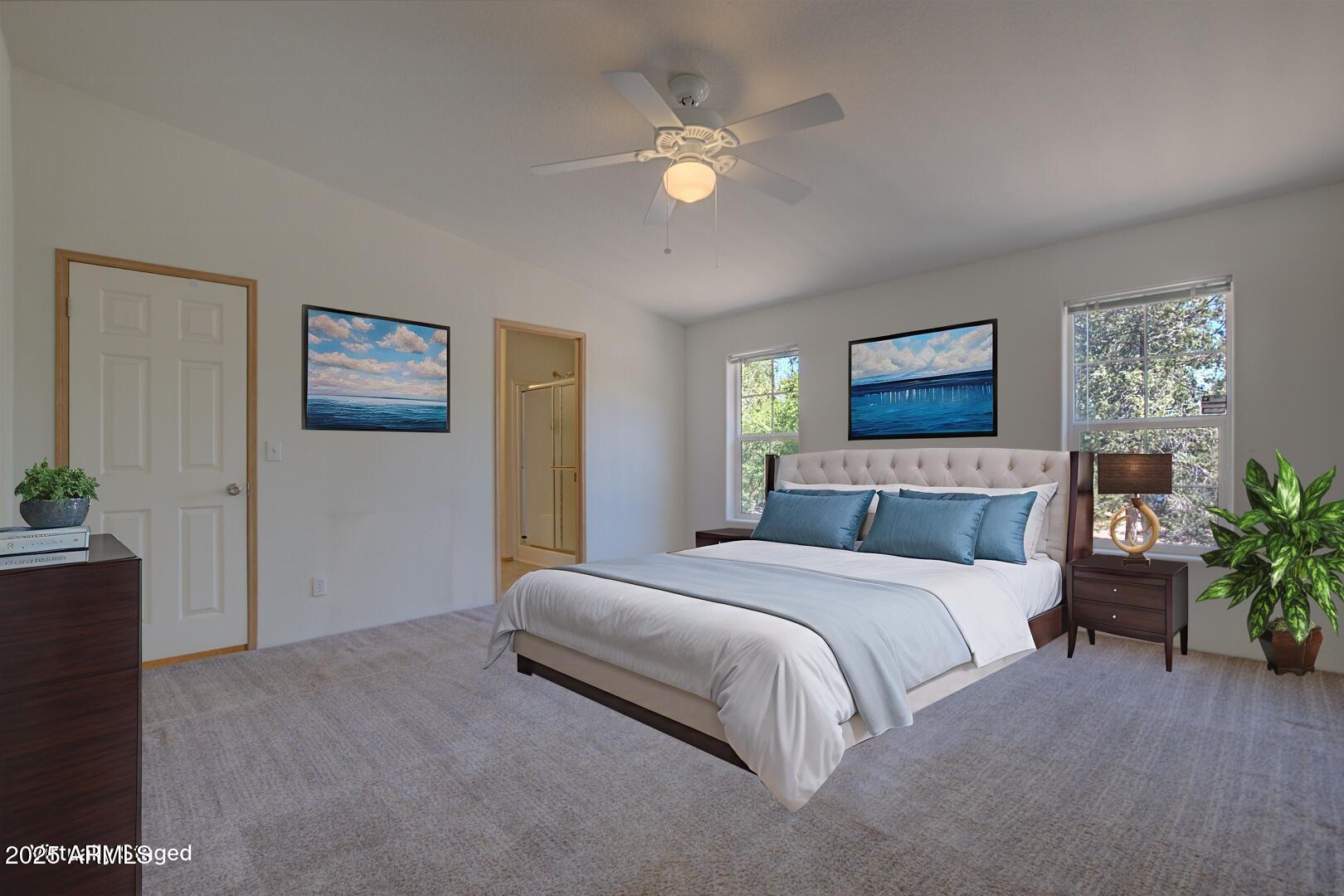 405 East Cherry Street Payson, AZ 85541 - Photo 22 of 47 a spacious bedroom with a bed and a potted plant